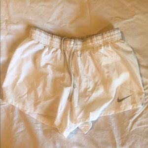 Nike women’s dri-fit shorts white with gray trim.